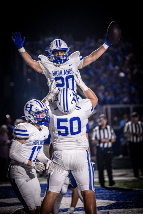 Max Merz (11) lifts Gabe Williams (10) after a Bluebird touchdown.
